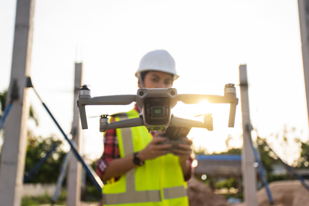Worker Using Drone on Site