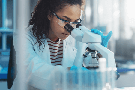 Black Scientist Looking Under Microscope