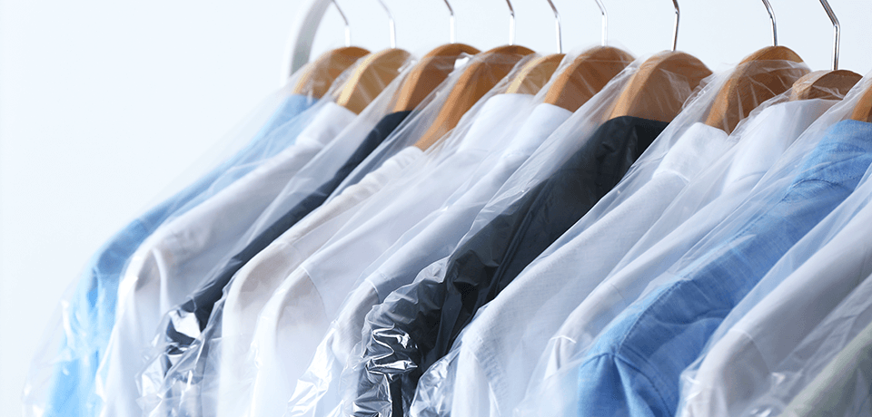 Rack of Dry-Cleaned Clothes on Hangers