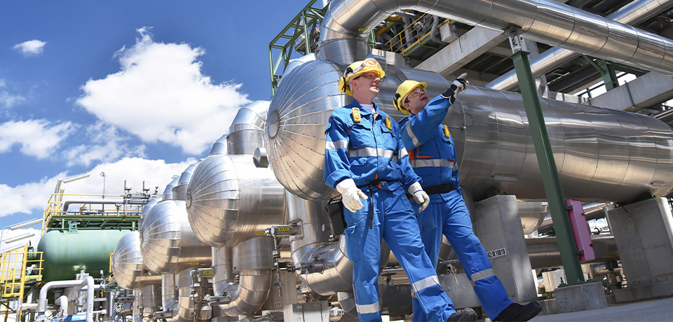 Two Workers Walking Through Chemical Facility