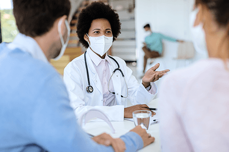 Couple Receiving Medical Consultation with Masks