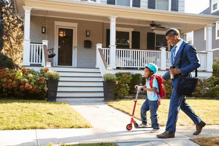 Father and Son Walking Down Street Together