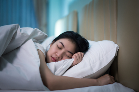 Woman Sleeping in Hotel Room
