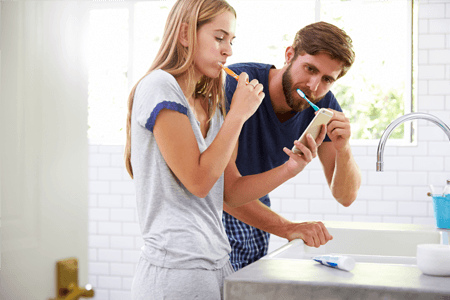 Couple Brushes Teeth with Toothpaste